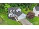 An aerial view shows this two-story home with lush landscaping, an attached garage, and well-maintained lawns at 8302 Holbrook Square Ct, Charlotte, NC 28216