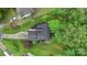 An aerial view of the house, the manicured lawn, and the surrounding lush green trees at 8302 Holbrook Square Ct, Charlotte, NC 28216