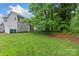 A spacious yard with a white fence, lush green grass, and plenty of room for outdoor activities at 8302 Holbrook Square Ct, Charlotte, NC 28216
