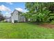 A spacious yard with a white fence, lush green grass, and plenty of room for outdoor activities at 8302 Holbrook Square Ct, Charlotte, NC 28216