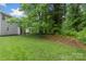 A spacious yard with a white fence, lush green grass, and plenty of room for outdoor activities at 8302 Holbrook Square Ct, Charlotte, NC 28216