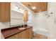 Bathroom with wooden vanity, updated fixtures and a tub-shower combination at 8302 Holbrook Square Ct, Charlotte, NC 28216