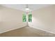 A bright bedroom featuring a ceiling fan and multiple windows at 8302 Holbrook Square Ct, Charlotte, NC 28216