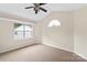 Bedroom with ceiling fan, sloped ceiling and a view to the outside at 8302 Holbrook Square Ct, Charlotte, NC 28216