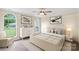Bright bedroom with a large window, a neutral color palette and stylish decor at 8302 Holbrook Square Ct, Charlotte, NC 28216