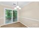 Dining area with sliding glass doors providing natural light and access to outdoor patio at 8302 Holbrook Square Ct, Charlotte, NC 28216