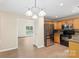 Modern kitchen featuring stainless steel appliances, light wood cabinetry, and granite countertops at 8302 Holbrook Square Ct, Charlotte, NC 28216