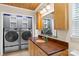 Laundry room with cabinetry, a wood countertop, and modern washer and dryer at 8302 Holbrook Square Ct, Charlotte, NC 28216