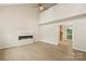 An open floor plan shows the cozy living room with fireplace and wood-look floors at 8302 Holbrook Square Ct, Charlotte, NC 28216