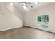 The living room has light walls, stairs, hardwood-look flooring, and lots of natural light at 8302 Holbrook Square Ct, Charlotte, NC 28216