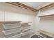 Walk-in closet offering shelving and metal basket storage for optimal organization at 8302 Holbrook Square Ct, Charlotte, NC 28216
