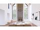 Elegant living room with high ceilings, large windows, and a cozy fireplace at 866 Concord Rd # 1C, Davidson, NC 28036
