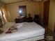 Bedroom featuring a cozy bed, dresser, and a mirror at 868 Alexis High Shoals Rd, Dallas, NC 28034