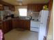 Kitchen features light cabinets, white appliances, and a functional layout at 868 Alexis High Shoals Rd, Dallas, NC 28034