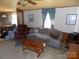 A traditional living room featuring a comfortable couch, armchair, and ceiling fan at 868 Alexis High Shoals Rd, Dallas, NC 28034
