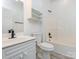 Bright bathroom featuring a shower and tub combo, toilet, vanity, and storage cabinets at 8747 Coralbell Ln, Charlotte, NC 28213