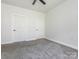 A bedroom includes neutral walls, carpet flooring, and two doors offering a comfortable living space at 8747 Coralbell Ln, Charlotte, NC 28213