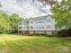 Multi-story building showcasing balconies, red brick accents, and well-maintained landscaping at 8747 Coralbell Ln, Charlotte, NC 28213