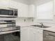 Well-appointed kitchen with stainless steel appliances and white cabinets at 8747 Coralbell Ln, Charlotte, NC 28213