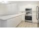 Modern kitchen features white cabinets, stainless steel appliances, and bright lighting at 8747 Coralbell Ln, Charlotte, NC 28213