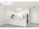 All-white kitchen with stainless steel appliances, and breakfast bar at 8747 Coralbell Ln, Charlotte, NC 28213