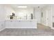 Open-concept kitchen with modern stainless appliances, including range, microwave, and refrigerator, perfect for cooking at 8747 Coralbell Ln, Charlotte, NC 28213