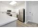 Bright kitchen with white cabinetry, stainless steel appliances and bar top at 8747 Coralbell Ln, Charlotte, NC 28213
