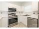 Bright kitchen with stainless steel appliances, white cabinetry, and ample countertop space at 8747 Coralbell Ln, Charlotte, NC 28213