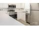 Kitchen view with white cabinets, stainless steel appliances including stove, dishwasher, and microwave at 8747 Coralbell Ln, Charlotte, NC 28213