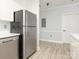 A modern kitchen features stainless steel appliances and white cabinetry providing a clean and efficient cooking space at 8747 Coralbell Ln, Charlotte, NC 28213