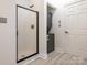 This functional laundry area features a stackable washer and dryer unit and a enclosed shower at 8747 Coralbell Ln, Charlotte, NC 28213