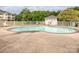 Sparkling swimming pool with a brick border, concrete deck, and adjacent pool house at 8747 Coralbell Ln, Charlotte, NC 28213