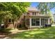 Angle view of the backyard highlighting the enclosed patio area and brick exterior of the home at 9001 Peyton Randolph Dr, Charlotte, NC 28277