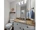 Charming bathroom with granite countertops, white cabinets, and a decorative Heinz ketchup sign at 9001 Peyton Randolph Dr, Charlotte, NC 28277