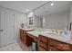 Bathroom with dual sinks, vanity, a large mirror, and ample storage space at 9001 Peyton Randolph Dr, Charlotte, NC 28277