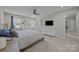 Spacious bedroom featuring two windows, a ceiling fan, and two dressers at 9001 Peyton Randolph Dr, Charlotte, NC 28277