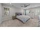 Comfortable bedroom with a modern ceiling fan, carpet floors, and ample natural light at 9001 Peyton Randolph Dr, Charlotte, NC 28277