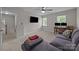 This bedroom features a comfy grey couch, a modern ceiling fan, and a desk for convenient computing at 9001 Peyton Randolph Dr, Charlotte, NC 28277