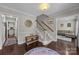 Bright foyer with hardwood floors, staircase, and views into the living spaces at 9001 Peyton Randolph Dr, Charlotte, NC 28277
