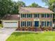 Charming brick two-story home with well-manicured lawn and attached two car garage at 9001 Peyton Randolph Dr, Charlotte, NC 28277