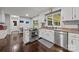 Bright kitchen featuring stainless steel appliances, wood floors, and a window over the sink at 9001 Peyton Randolph Dr, Charlotte, NC 28277