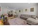 Spacious living room with hardwood floors, a comfortable sofa, and an open layout at 9001 Peyton Randolph Dr, Charlotte, NC 28277
