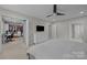 Main bedroom showcasing walk-in closet, ceiling fan, a tv and a dresser at 9001 Peyton Randolph Dr, Charlotte, NC 28277