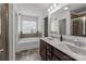 Bright bathroom featuring a double sink vanity, large mirror, and a separate tub and shower at 9132 Colwick Hill Ln, Charlotte, NC 28215