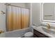 Bathroom featuring a shower and tub combination with shower curtain, granite counters, and a decorative sink at 9132 Colwick Hill Ln, Charlotte, NC 28215