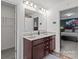 Bathroom vanity area with double sinks and granite countertops, offering ample storage at 9132 Colwick Hill Ln, Charlotte, NC 28215