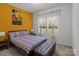Comfortable bedroom featuring a window, nightstands, and a comfortable bed with a bench at the foot at 9132 Colwick Hill Ln, Charlotte, NC 28215