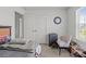 Neutral bedroom features a closet, accent chair, luggage and a decorative wall clock at 9132 Colwick Hill Ln, Charlotte, NC 28215