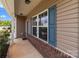 Inviting covered porch showcases brick accents and stylish design elements at 9132 Colwick Hill Ln, Charlotte, NC 28215