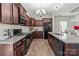 Kitchen area featuring an island with granite counters, wood cabinets, and stainless steel appliances at 9132 Colwick Hill Ln, Charlotte, NC 28215